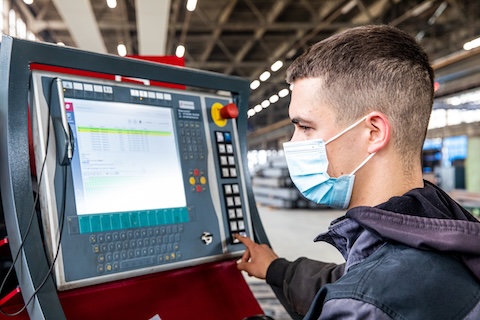 Engineer working on plasma steel cutting machine