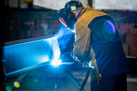 Welder working with steel