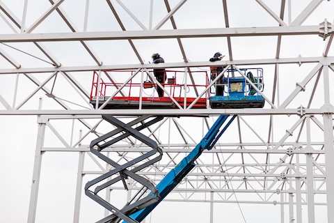 Contruction workers on a scissor platform